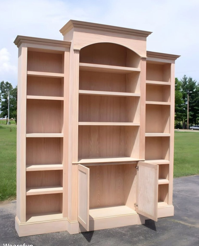 Three-bay arched valance bookcase and entertainment center built-in by Rodriguez Cabinets in Houston