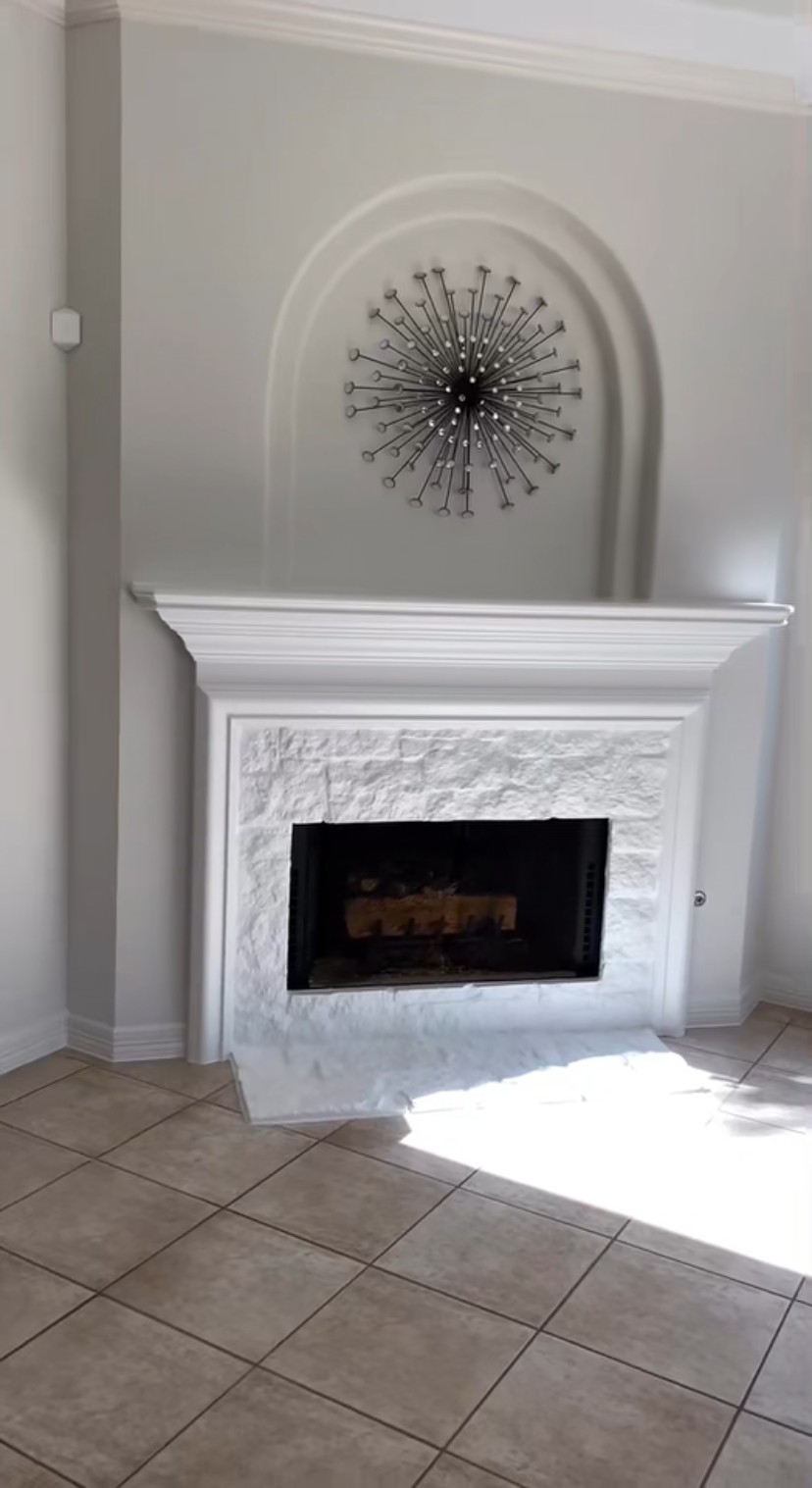 Custom fireplace mantel and stone surround by Rodriguez Cabinets in Houston