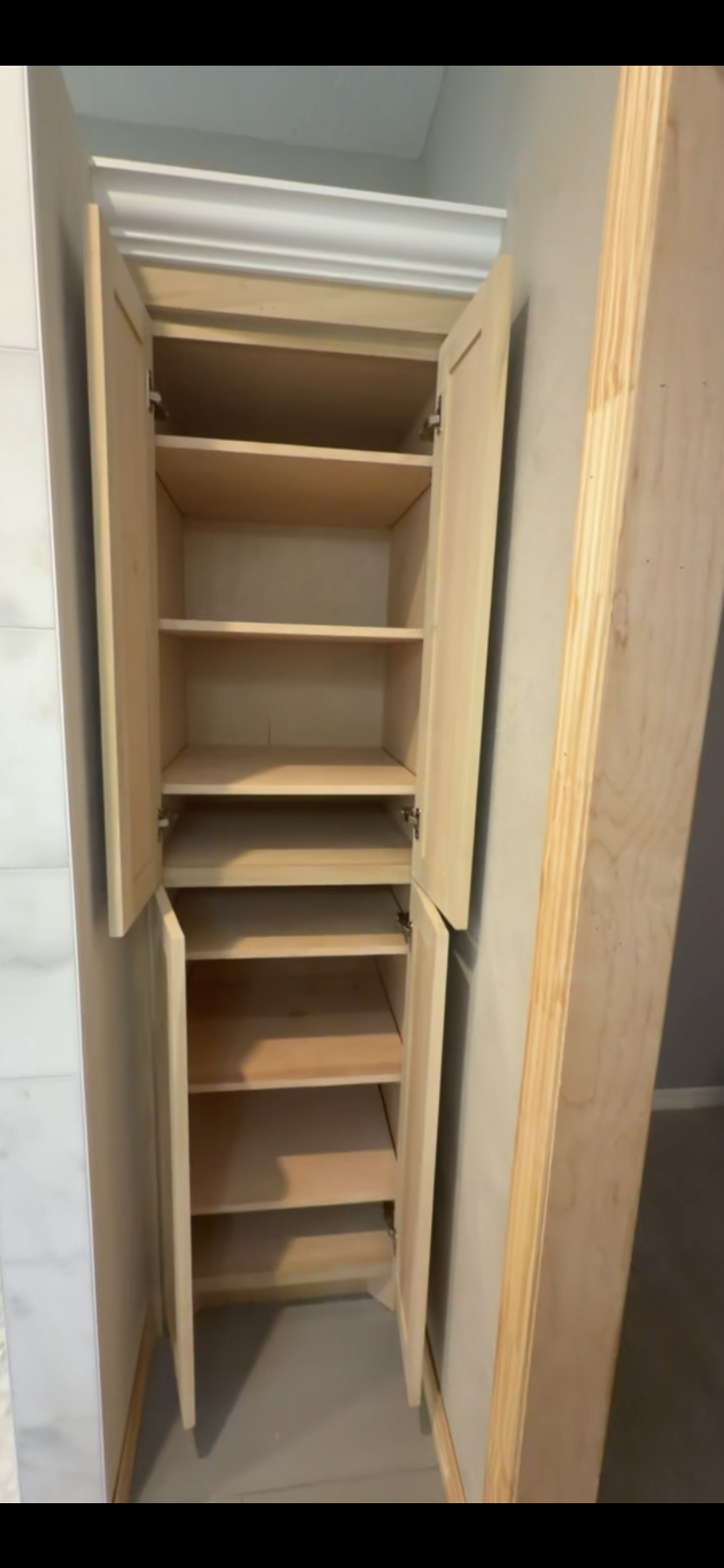 Natural maple corner pantry interior with adjustable shelves by Rodriguez Cabinets in Houston