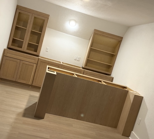 Natural maple kitchen and island installation by Rodriguez Cabinets in Houston