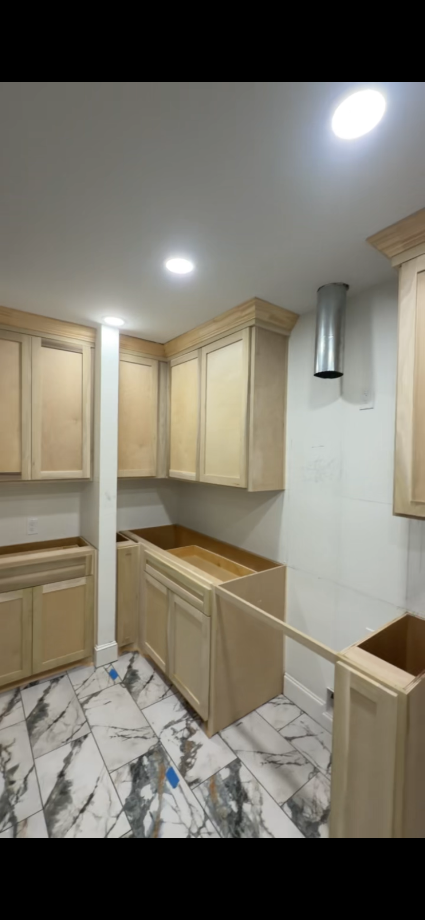 Crown-molded natural maple kitchen cabinets by Rodriguez Cabinets in Houston
